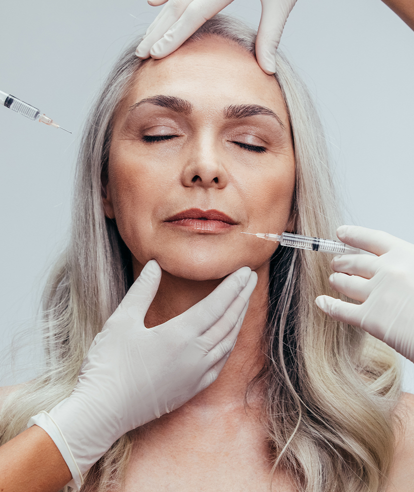 Middle aged woman getting injections on her face